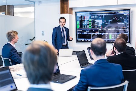 Business man making a presentation at office. Business executive delivering a presentation to his colleagues during meeting or in-house business training, explaining business plans to his employees. Stock Photo - Budget Royalty-Free & Subscription, Code: 400-09170665