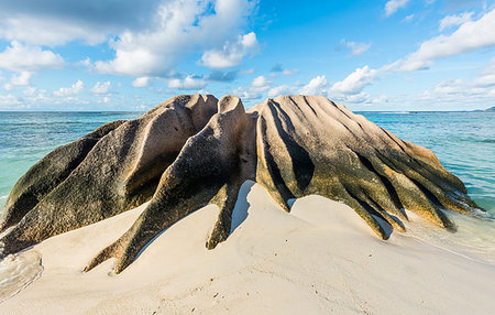Beautifully shaped granite boulder in the sea shot in long exposure at Anse Source d'Argent beach, La Digue island, Seychelles Stock Photo - Budget Royalty-Free & Subscription, Code: 400-09224258