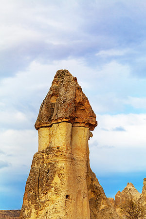 Cylindrical stone cliffs and cave houses near Goreme, Turkey Stock Photo - Budget Royalty-Free & Subscription, Code: 400-09225415