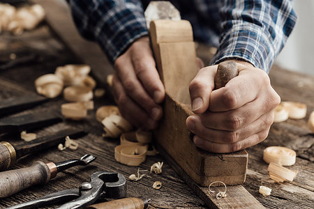 simsearch:600-00073204,k - Carpenter working in his workshop, he is smoothing a wooden board using a planer, carpentry, carpentry, woodworking and craftsmanship concept Stock Photo - Budget Royalty-Free & Subscription, Code: 400-09221576