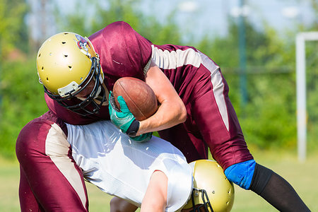 football tackle american - Attack at American Football Game being blocked by player Stock Photo - Budget Royalty-Free & Subscription, Code: 400-09221806