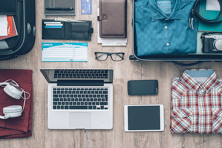 Travel equipment on a desktop: clothing, wallet, laptop, tablet, smartphone and personal accessories, travel and vacations concept Stock Photo - Budget Royalty-Free & Subscription, Code: 400-09222181