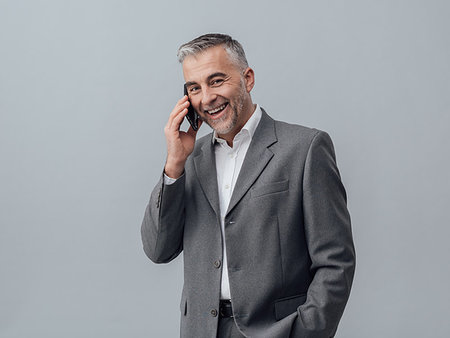 simsearch:859-06710917,k - Confident smiling businessman having a phone call with his smartphone Stock Photo - Budget Royalty-Free & Subscription, Code: 400-09222944