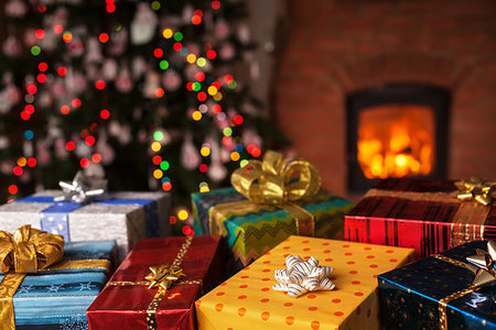Many christmas presents in front of xmas tree and fireplace in a dark room Stock Photo - Budget Royalty-Free & Subscription, Code: 400-09237775
