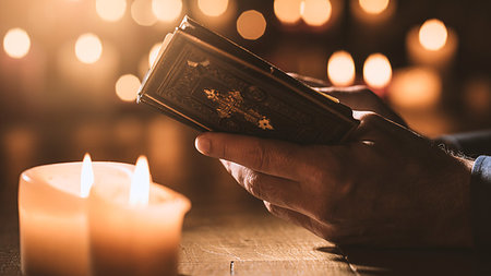 simsearch:400-05890930,k - Religious man reading the Holy Bible and praying in the Church with lit candles, religion and faith concept Stock Photo - Budget Royalty-Free & Subscription, Code: 400-09273829