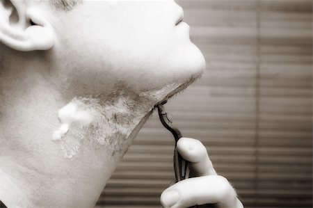 sepia bathroom - Man shaving his beard off. Looking in the mirror. Sepia tone. Stock Photo - Budget Royalty-Free & Subscription, Code: 400-03907815