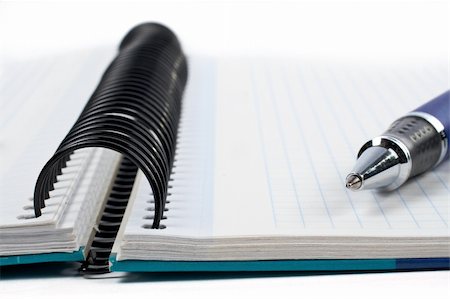 simsearch:6109-08395080,k - Detail of pen and notebook with shadow over a white background. Small DOF Stock Photo - Budget Royalty-Free & Subscription, Code: 400-03908973