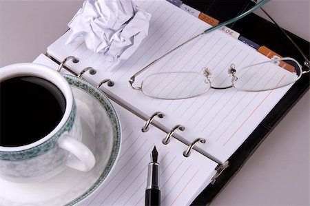 simsearch:6109-08395080,k - Close up of eyeglasses, coffee, pen and crumpled paper. Stock Photo - Budget Royalty-Free & Subscription, Code: 400-03909029