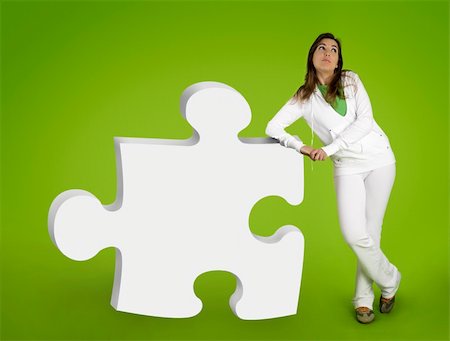 simsearch:400-04109331,k - Woman contemplating questions with 3D puzzle form on a green background Stock Photo - Budget Royalty-Free & Subscription, Code: 400-03915333