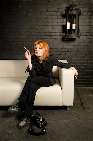 smoker girl - Female with dyed orange hair sitting on a couch smoking a cigarette. Stock Photo - Budget Royalty-Free & Subscription, Code: 400-03915516