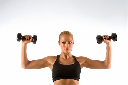 simsearch:400-03976636,k - Blonde female working out with black dumbbells Stock Photo - Budget Royalty-Free & Subscription, Code: 400-03916342