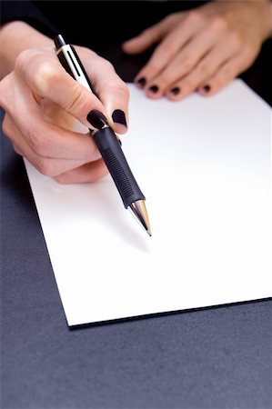 Close-up of hand holding pen pointing to blank document Stock Photo - Budget Royalty-Free & Subscription, Code: 400-03910713