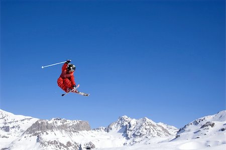 simsearch:400-03985663,k - a skier jumping high through a blue sky, with mountain range in background Stock Photo - Budget Royalty-Free & Subscription, Code: 400-03911594