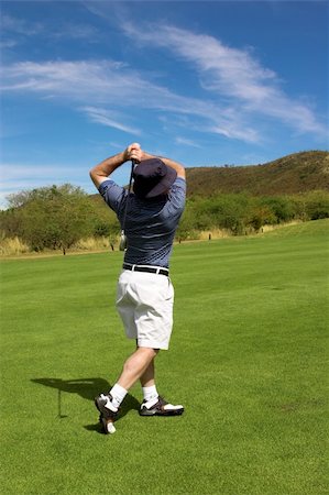 Golfer hitting the ball from the fairway. Stock Photo - Budget Royalty-Free & Subscription, Code: 400-03912170