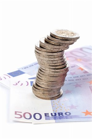 simsearch:600-00077457,k - Stack of coins over a euro bills background. Soft shadow Stock Photo - Budget Royalty-Free & Subscription, Code: 400-03912548