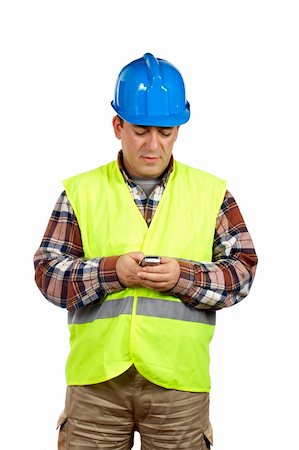 simsearch:400-06632132,k - Construction worker with green safety vest sending sms with cell phone over a white background Stock Photo - Budget Royalty-Free & Subscription, Code: 400-03912900