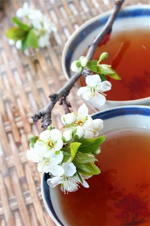simsearch:659-06184015,k - Tea in antique Chinese Porcelain cups (genuine 18th Century) and peach blossom on wicket table Stock Photo - Budget Royalty-Free & Subscription, Code: 400-03913718