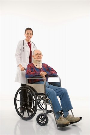 Mid-adult Caucasian female doctor pushing elderly Caucasian male with neck brace in wheelchair. Stock Photo - Budget Royalty-Free & Subscription, Code: 400-03924226