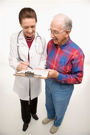 Mid-adult Caucasian female doctor showing papers to elderly Caucasian male. Stock Photo - Budget Royalty-Free & Subscription, Code: 400-03924228