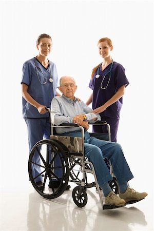 Two Caucasian females wearing scrubs with elderly Caucasian male in wheelchair. Stock Photo - Budget Royalty-Free & Subscription, Code: 400-03924240