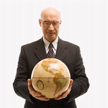 Caucasian middle-aged businessman holding globe in both hands standing in front of white background. Stock Photo - Budget Royalty-Free & Subscription, Code: 400-03924334