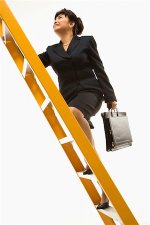 Filipino middle-aged businesswoman climbing ladder carrying briefcase. Stock Photo - Budget Royalty-Free & Subscription, Code: 400-03924341