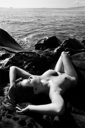 simsearch:400-04450827,k - Sexy Caucasian young adult woman sunbathing nude on rocks at Maui coast. Stock Photo - Budget Royalty-Free & Subscription, Code: 400-03924902