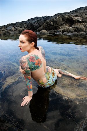 simsearch:400-04450827,k - Back view of nude sexy Caucasian tattooed woman in bikini lying in tidal pool in Maui, Hawaii, USA. Stock Photo - Budget Royalty-Free & Subscription, Code: 400-03925234