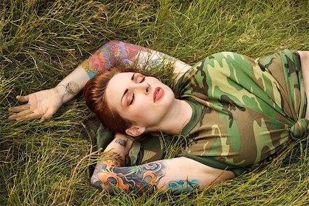 simsearch:400-04450827,k - Attractive tattooed Caucasian woman in camouflage lying on grass in Maui, Hawaii, USA. Stock Photo - Budget Royalty-Free & Subscription, Code: 400-03925231
