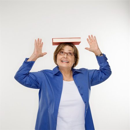 simsearch:649-06532718,k - Caucasian middle aged woman balancing book on head. Stock Photo - Budget Royalty-Free & Subscription, Code: 400-03925649