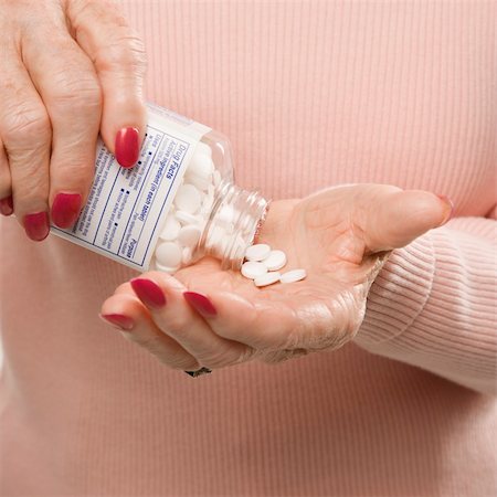 simsearch:400-04450069,k - Caucasian senior female hands pouring pills from container. Stock Photo - Budget Royalty-Free & Subscription, Code: 400-03925663