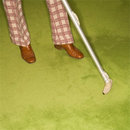 Close-up of Caucasian male feet with vacuum extension against green retro carpet. Stock Photo - Budget Royalty-Free & Subscription, Code: 400-03925742