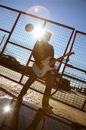 desolation sound - cool guy playing his guitar against sunlight Stock Photo - Budget Royalty-Free & Subscription, Code: 400-03927287