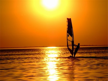 simsearch:400-03992760,k - Silhouette of a windsurfer on waves of a gulf on a sunset Stock Photo - Budget Royalty-Free & Subscription, Code: 400-03927343