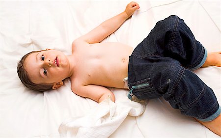 baby posing on white sheet wearing blue pans Stock Photo - Budget Royalty-Free & Subscription, Code: 400-03927855