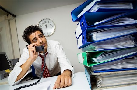 simsearch:6108-06167824,k - exhausted businessman in his office surrounded by files Stock Photo - Budget Royalty-Free & Subscription, Code: 400-03927892
