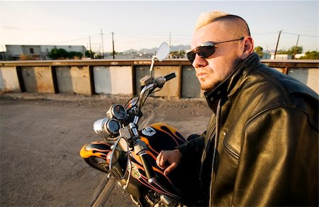 simsearch:400-03927951,k - Man with a punk haircut in a leather jacket sitting on his motorcycle. Stock Photo - Budget Royalty-Free & Subscription, Code: 400-03927957