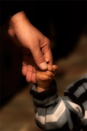 simsearch:859-06808650,k - Image shows a hand of an adult holding the hand of a small child Stock Photo - Budget Royalty-Free & Subscription, Code: 400-03928179
