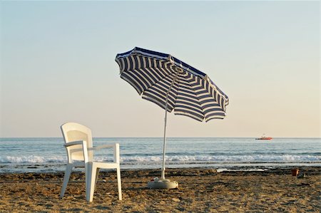 simsearch:400-03991814,k - chair and umbrella on sand beach near by sea Stock Photo - Budget Royalty-Free & Subscription, Code: 400-03928219