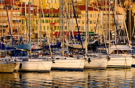 simsearch:700-00031108,k - The Vieux Port (old port) in the city of Cannes in the French riviera, as the first rays of the morning sun illuminate the marina and the buildings behind the boats. Stock Photo - Budget Royalty-Free & Subscription, Code: 400-03928268