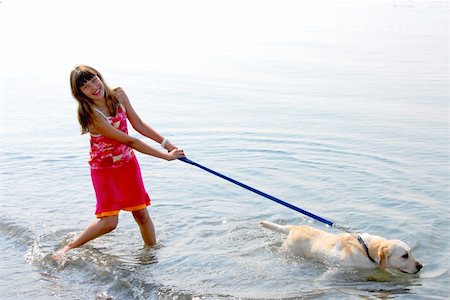 dog leash girl - Happy girl playing with her dog in water Stock Photo - Budget Royalty-Free & Subscription, Code: 400-03928835