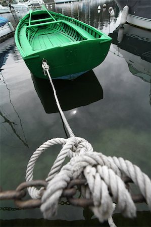 simsearch:400-04433053,k - Green boat tied up with rope to a harbor. Concept: Sailing vacation. Stock Photo - Budget Royalty-Free & Subscription, Code: 400-03928933