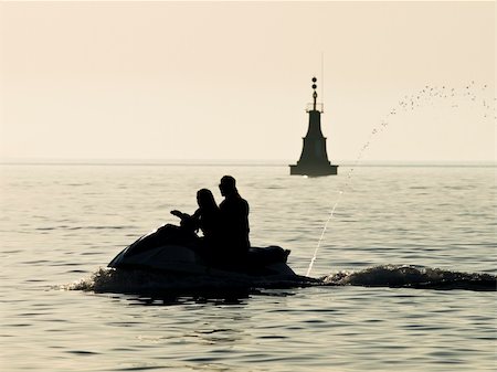 simsearch:400-07748817,k - Driving a jet ski at sunset Stock Photo - Budget Royalty-Free & Subscription, Code: 400-03928963