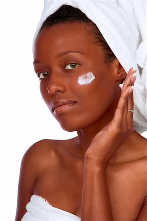 simsearch:400-03950910,k - African-American girl applying facial skincare product (isolated) Photographie de stock - Aubaine LD & Abonnement, Code: 400-03929252