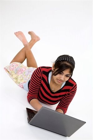 school india - Portrait of Indian teenager working with a laptop conputer on a white background Stock Photo - Budget Royalty-Free & Subscription, Code: 400-03929840