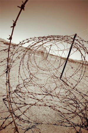 prison guard - barbed wire at the border of a mine field Stock Photo - Budget Royalty-Free & Subscription, Code: 400-03922143