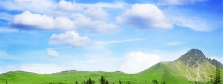 simsearch:400-03934248,k - a green meadow on a mountain under the beautiful blue sky with clouds Stock Photo - Budget Royalty-Free & Subscription, Code: 400-03923331