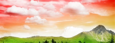 simsearch:400-04581013,k - a green meadow on a mountain under the beautiful red and yellow sky in sunset Stock Photo - Budget Royalty-Free & Subscription, Code: 400-03923332