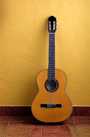 simsearch:400-04570412,k - Guitar leaned to a yellow wall Stock Photo - Budget Royalty-Free & Subscription, Code: 400-03934237