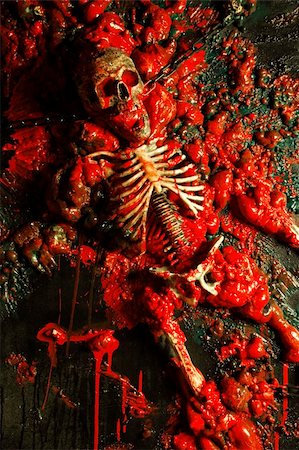 simsearch:400-04275576,k - Halloween image / background of blood, bones and guts.  Sculpture was built by me from a plastic skeleton, so I hold any copyrights. Photographie de stock - Aubaine LD & Abonnement, Code: 400-03934594